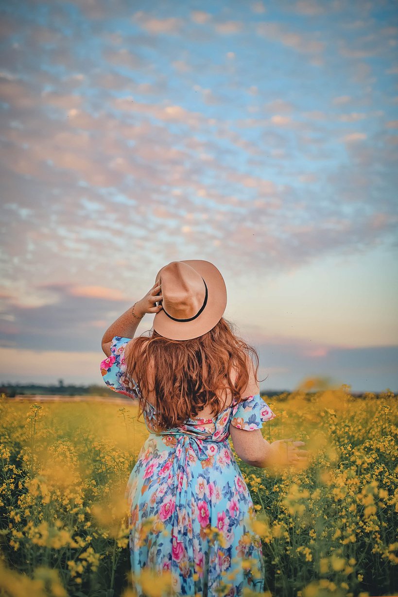 Woman Walking on Yellow Flower Field